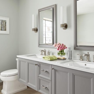A white bathroom with pink flowers on the counter
