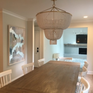 dining-room-view A wooden table with chandelier above it.