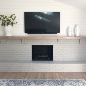 family-room-fireplace A fireplace inside of white bricks with a television above it on a shelf