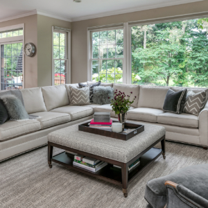 preservation-and-renovation-living-room A decorative sun-lit living room with flowers on a coffee table.