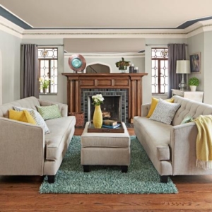 Two white couches facing each other in front of a fireplace