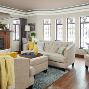 A living room with wood floors and white couches